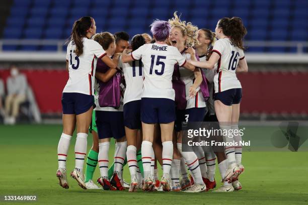 Megan Rapinoe of Team United States celebrates with Samantha Mewis and team mates following their team's victory in the penalty shoot out during the...