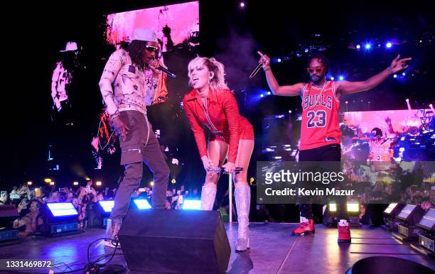 Miley Cyrus performs on stage with Wiz Khalifa and Juicy J during Lollapalooza 2021 at Grant Park on July 29, 2021 in Chicago, Illinois.