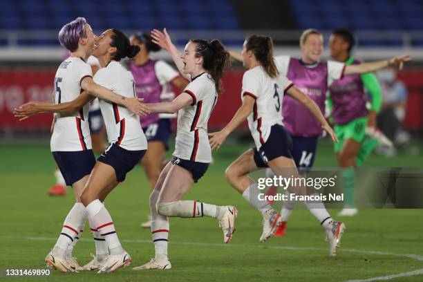 Megan Rapinoe of Team United States celebrates with Christen Press and Rose Lavelle following their team's victory in the penalty shoot out during...