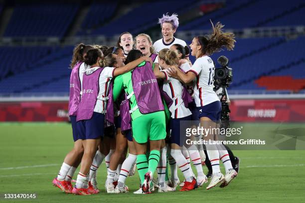 Megan Rapinoe of Team United States celebrates with Rose Lavelle and team mates following their team's victory in the penalty shoot out during the...