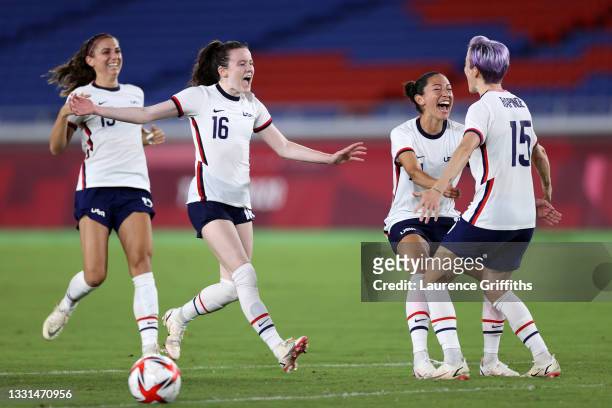 Alex Morgan, Rose Lavelle, Christen Press and Megan Rapinoe of Team United States celebrate following their team's victory in the penalty shoot out...