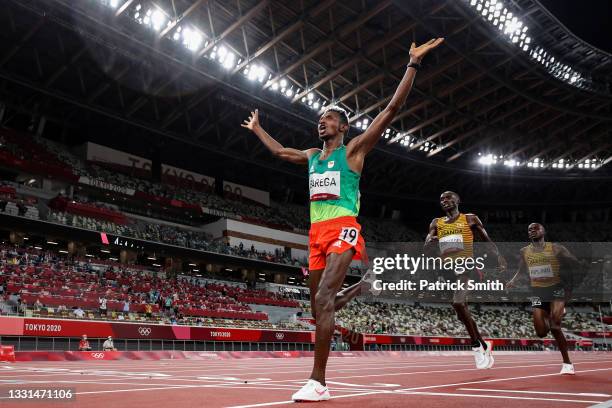Gold medalist Selemon Barega of Team Ethiopia celebrates as he crosses the finish line ahead of silver medalist Joshua Cheptegei of Team Uganda and...