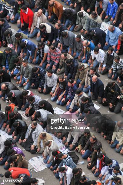 High-angle view of demonstrators as they kneel and pray in Tahrir Square, Cairo, Egypt, February 1, 2011. Representing a wide spectrum of the...