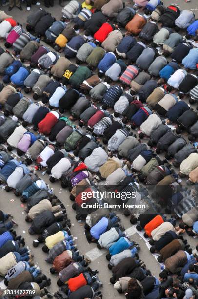 High-angle view of demonstrators as they kneel and pray in Tahrir Square, Cairo, Egypt, February 1, 2011. Representing a wide spectrum of the...