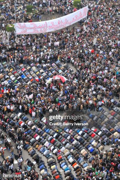 High-angle view of demonstrators, some of whom kneel and pray, in Tahrir Square, Cairo, Egypt, February 1, 2011. Representing a wide spectrum of the...