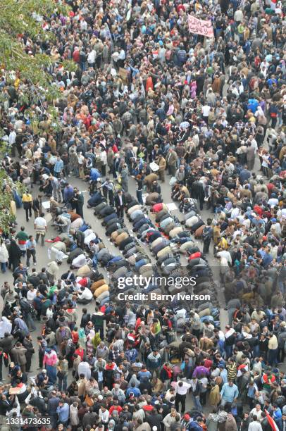 High-angle view of demonstrators, some of whom kneel and pray, in Tahrir Square, Cairo, Egypt, February 1, 2011. Representing a wide spectrum of the...