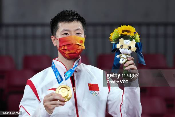 Gold medalist Ma Long of Team China celebrates on the podium after the Men's Table Tennis Singles Final match on day seven of the Tokyo 2020 Olympic...