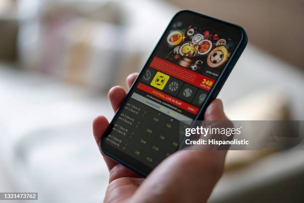 close-up on a man gambling on a football app - internet gambling stock pictures, royalty-free photos & images