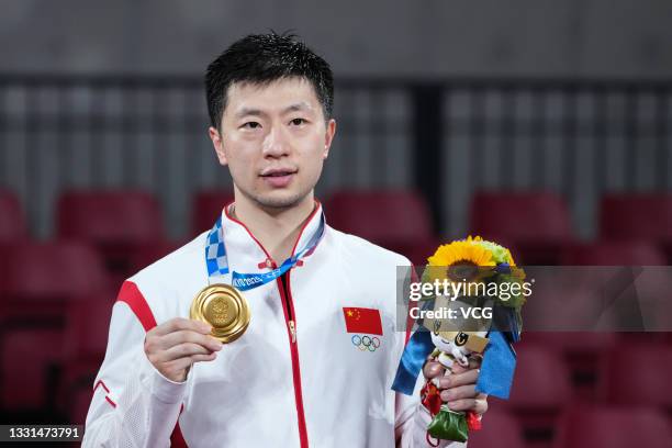 Gold medalist Ma Long of Team China celebrates on the podium after the Men's Table Tennis Singles Final match on day seven of the Tokyo 2020 Olympic...