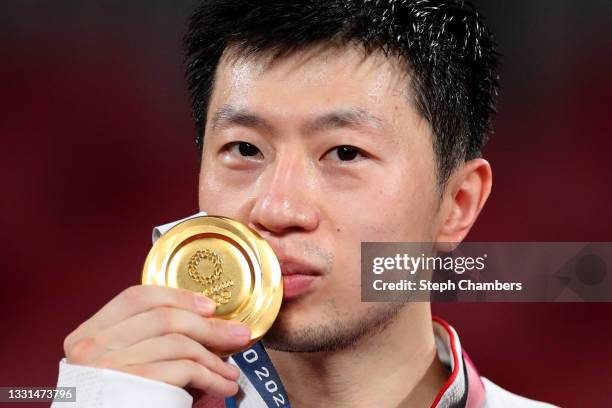 Ma Long of Team China kisses his medal after during the medal ceremony for the Men's Singles table tennis on day seven of the Tokyo 2020 Olympic...