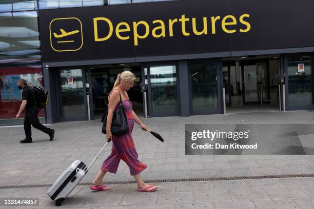 Travelers at Gatwick Airport on July 30, 2021 in London, England. Restrictions to and from the UK remain in place as Coronavirus continues to disrupt...