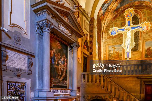 the famous crucifix painted by giotto inside the chiesa di ognissanti in the historic heart of florence - chapel icon stock pictures, royalty-free photos & images