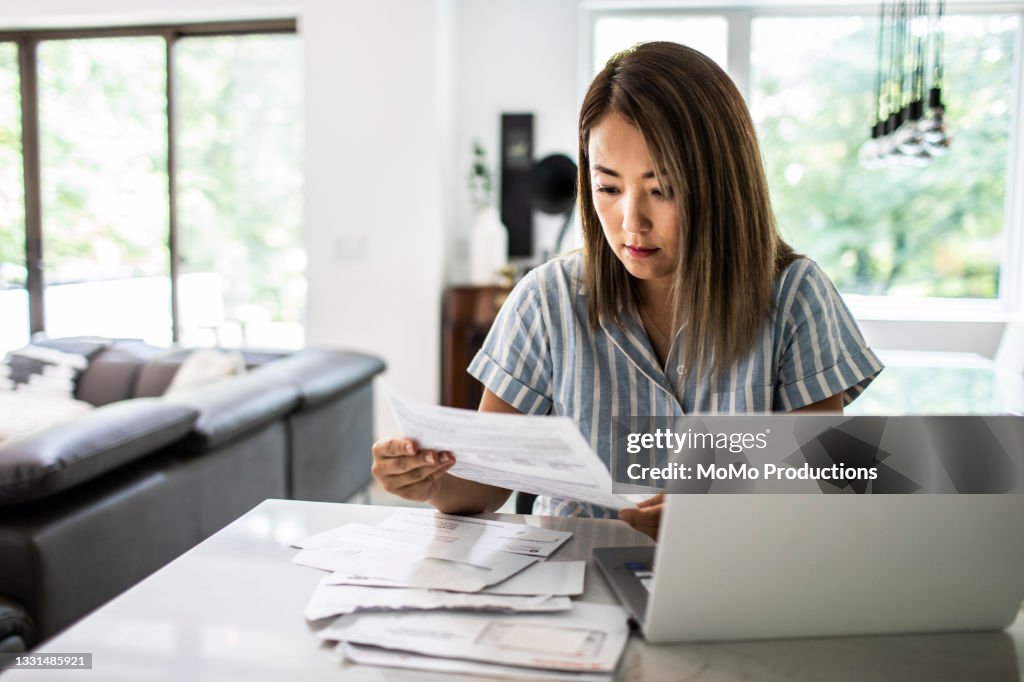 Woman paying bills at home