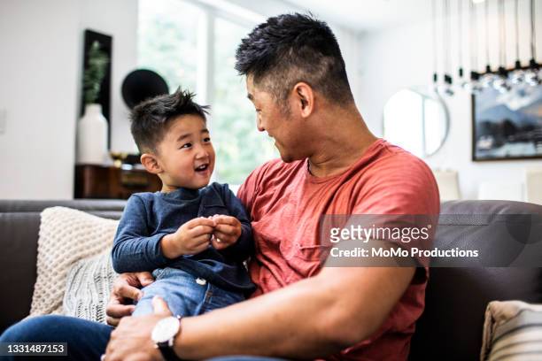 father talking with son at home - stories of the day stock pictures, royalty-free photos & images