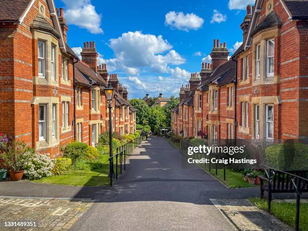 beautiful sunny street view in residential district with row of old expensive houses and apartments in london, uk - londen en omgeving stockfoto's en -beelden