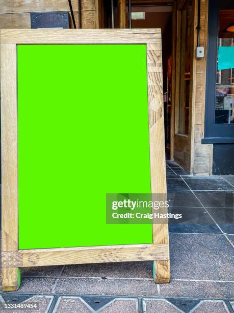 close up of shop a-frame sign with green screen chroma key advertising billboard space. shop and retail sales and special offers copy space london uk - aufsteller stock-fotos und bilder