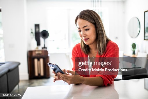 Woman using mobile device at home Woman using mobile device at home