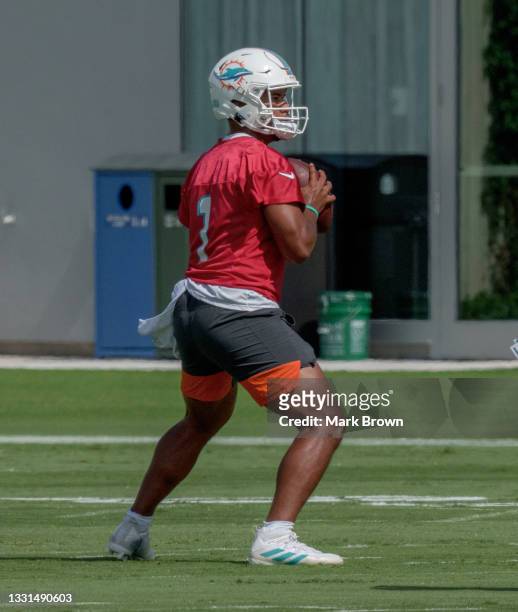 Quarterback Tua Tagovailoa of the Miami Dolphins performs practice drills during Training Camp at Baptist Health Training Complex on July 30, 2021 in...