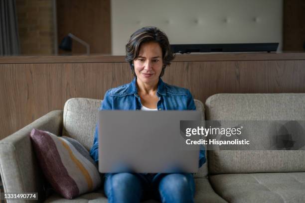 woman working from home on her laptop computer - writing email stock pictures, royalty-free photos & images