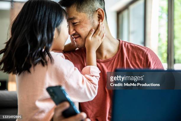 father working from home while distracted by children - leanincollection stock pictures, royalty-free photos & images