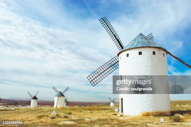 traditional windmills in la mancha - campo de criptana stockfoto's en -beelden