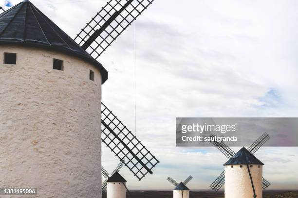 traditional windmills in la mancha - campo de criptana stockfoto's en -beelden