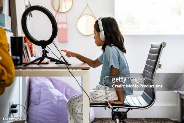 young girl using digital tablet at home - leanincollection stock pictures, royalty-free photos & images