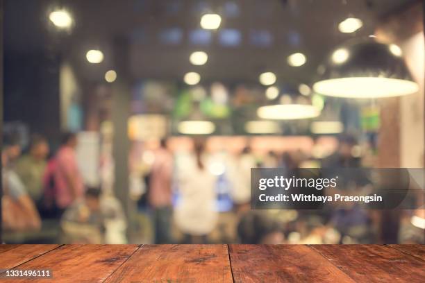 wood table top with blur of people in coffee shop - backgrounds people 個照片及圖片檔