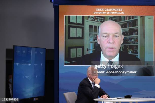 President Joe Biden listens as Montana Governor Greg Gianforte speaks during a virtual meeting with U.S. Vice President Kamala Harris and west coast...