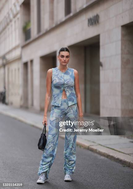 Celine Bethmann wearing Converse sneakers, black By Far bag and Jaded London two piece on July 28, 2021 in Berlin, Germany.