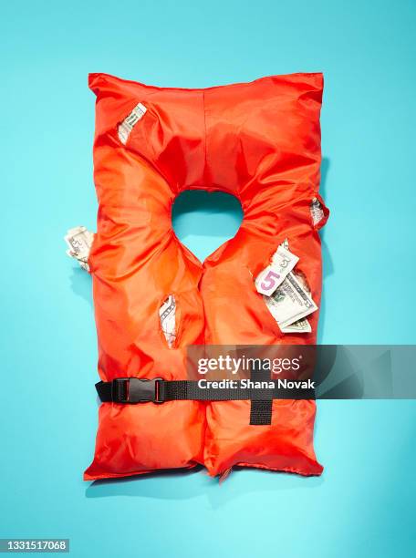 life jacket stuffed with money - life jacket stock-fotos und bilder