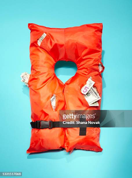 life jacket stuffed with money - flytväst bildbanksfoton och bilder
