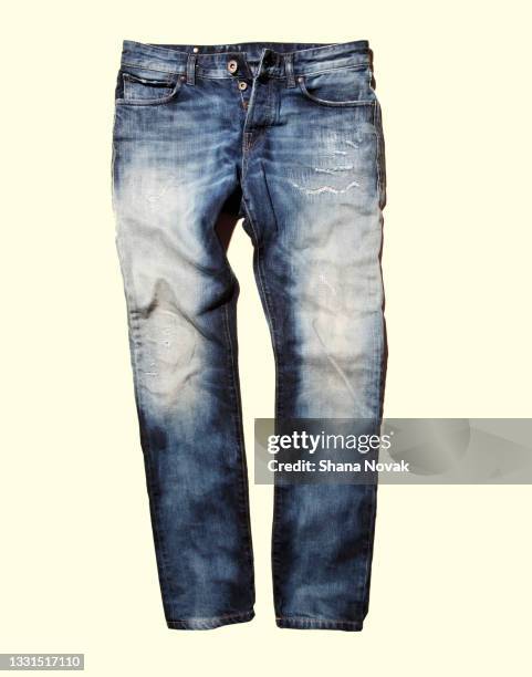 denim on a yellow background - denim jeans stock pictures, royalty-free photos & images