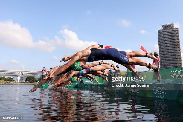 Summer Rappaport of Team United States and other competitors dive during the Mixed Relay Triathlon on day eight of the Tokyo 2020 Olympic Games at...
