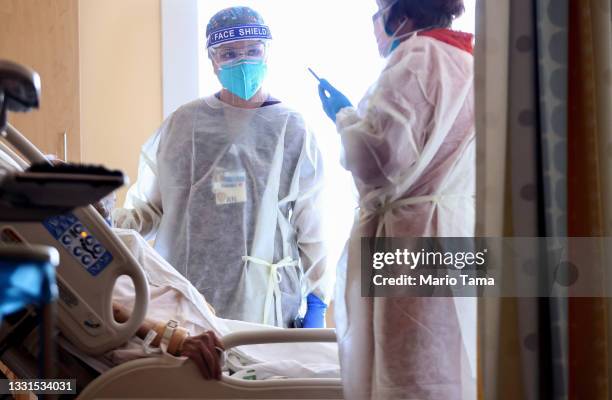 Registered nurse Elle Lauron cares for a COVID-19 patient in the improvised COVID-19 unit at Providence Holy Cross Medical Center in the Mission...