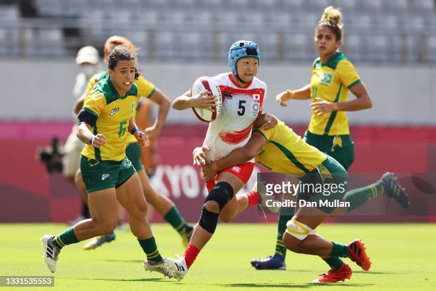 Yume Hirano of Team Japan is tackled in the Women’s Placing 11-12 match between Team Brazil and Team Japan during the Rugby Sevens on day eight of...