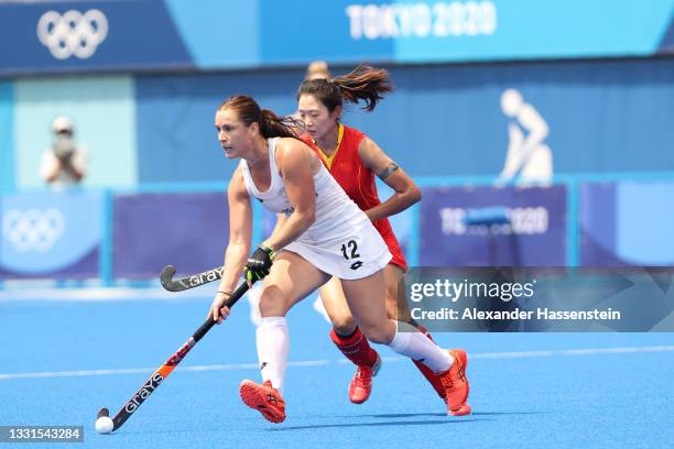 Na Wang of Team China chases Ella Gunson of Team New Zealand during the Women's Preliminary Pool B match between China and New Zealand on day eight...