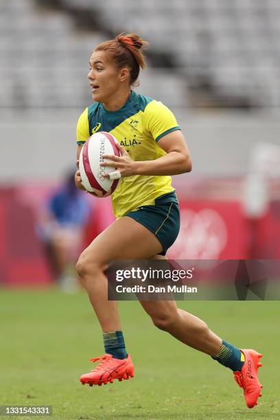 Madison Ashby of Team Australia runs with the ball in the Women’s Placing 5-8 match between Team ROC and Team Australia during the Rugby Sevens on...