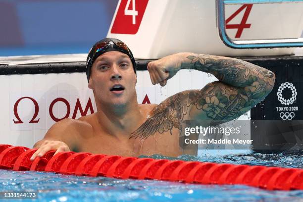 Caeleb Dressel of Team United States celebrates winning the gold medal and breaking the world record competing in the Men’s 100m Butterfly Final at...
