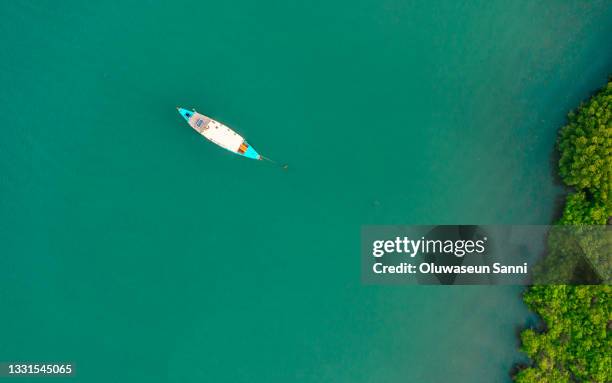 lone boat - gambia stock pictures, royalty-free photos & images