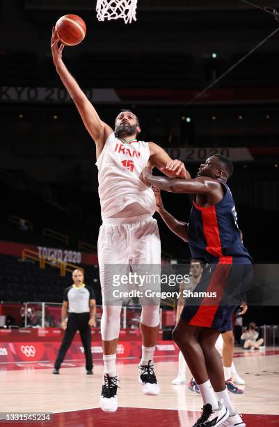 Hamed Haddadi of Team Iran goes up for a shot against Moustapha Fall of Team France during the first half of a Men's Basketball Preliminary Round...