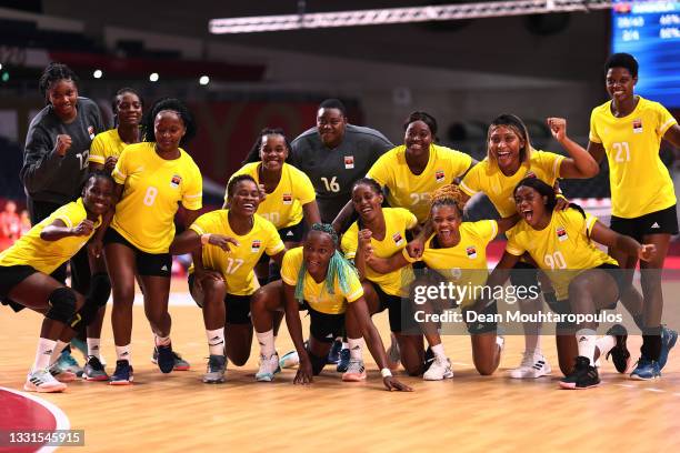 Team Angola celebrate after winning the Women's Preliminary Round Group A handball match between Angola and Japan on day eight of the Tokyo 2020...