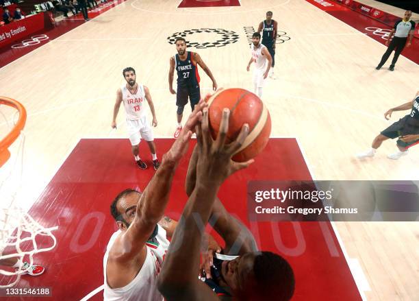 Moustapha Fall of Team France goes up for a shot against Hamed Haddadi of Team Iran during the first half of a Men's Basketball Preliminary Round...