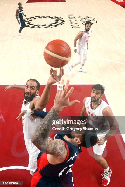 Hamed Haddadi of Team Iran goes up for a shot against Vincent Poirier of Team France during the first half of a Men's Basketball Preliminary Round...
