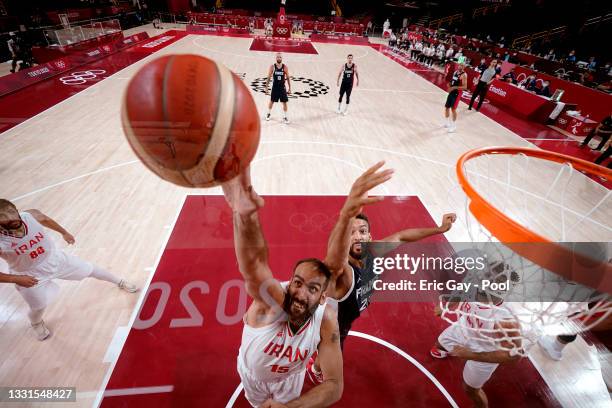 Hamed Haddadi of Team Iran and Rudy Gobert of Team France battle for a rebound during the second half of a Men's Basketball Preliminary Round Group A...