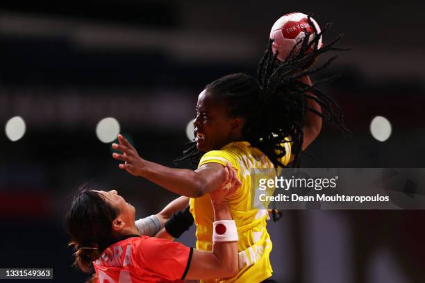 Marilia Quizelete of Team Angola shoots at goal whilst Ayaka Ikehara of Team Japan defends during the Women's Preliminary Round Group A handball...