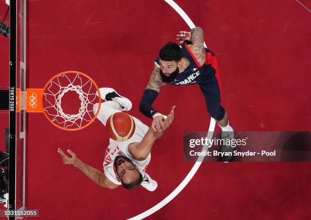 Vincent Poirier of Team France defends against Hamed Haddadi of Team Iran during the second half of a Men's Basketball Preliminary Round Group A game...