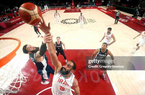 Vincent Poirier of Team France defends against Hamed Haddadi of Team Iran during the second half of a Men's Basketball Preliminary Round Group A game...