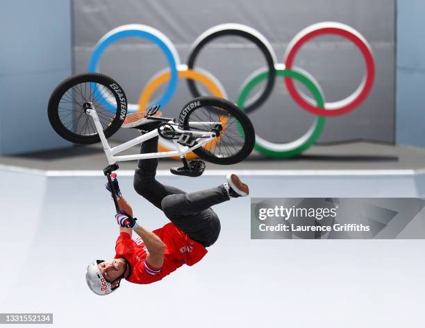 Kenneth Tencio Esquivel of Team Costa Rica performs a blackflip in front of the Olympic rings logo during the Men's BMX Freestyle seeding event, run...