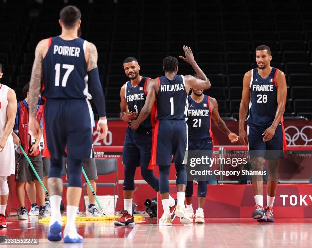 Frank Ntilikina of Team France celebrates a play with teammates during the first half of a Men's Basketball Preliminary Round Group A game against...